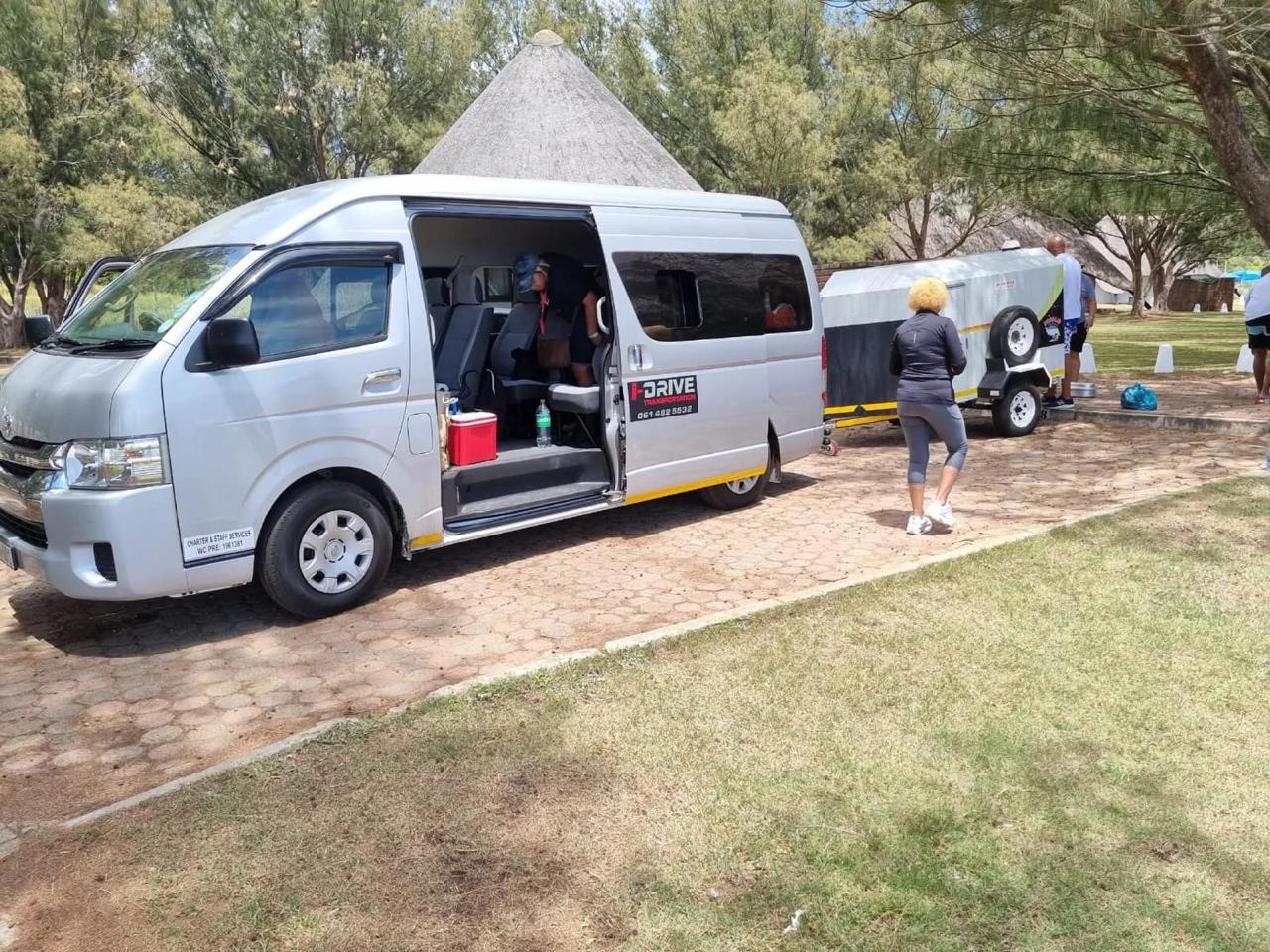 i-Drive minibus and luggage trailer at a corporate event venue